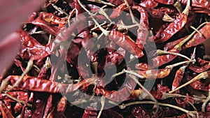 Chef's hand is holding red dried chili peppers to cook for Background.