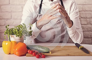 Chef`s hands. Man is ready to prepare fresh salad.