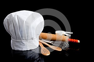 A Chef's toque with cooking utensils