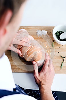 Chef seasoning raw meat