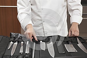 Chef Selecting Knife Sharpener Out Of Full Set