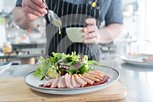 The chef serves roast duck.