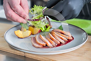 The chef serves roast duck.