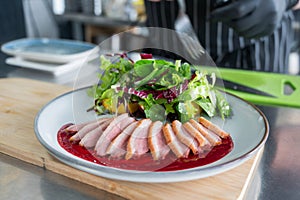 The chef serves roast duck.