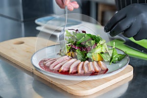 The chef serves roast duck.