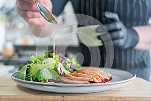 The chef serves roast duck.