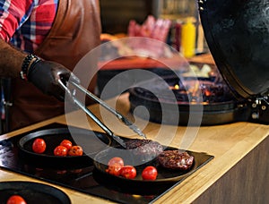 Chef serving freshly cooked meat in a restaurant