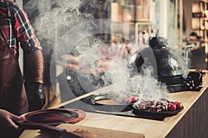 Chef serving freshly cooked meat in a restaurant