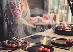 Chef serving freshly cooked ribs in a restaurant