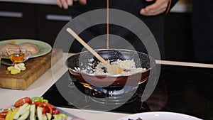 Chef serving wok on plate