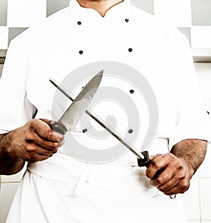 Chef Sharpening Kitchen Knife at Work