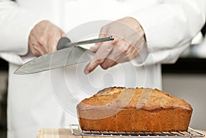 Chef Sharpens Knife Over Banana Bread