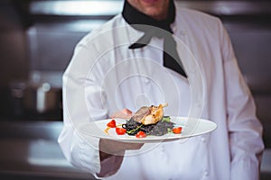 Chef showing plate of spaghetti