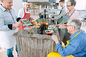 Chef showing trainees the secrets of healthy cooking in her kitchen