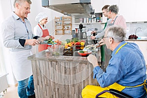 Chef showing trainees the secrets of healthy cooking in her kitchen