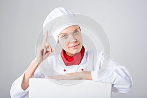 Chef Sign. Woman cook looking over paper sign billboard. Surprised and funny expression woman isolated on white background