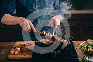 Chef skillfully grills flavorful barbecue skewers on a smoky stove top photo