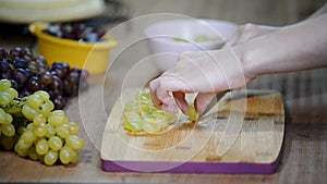 Chef sliced grapes on a cutting board Chef`s hands