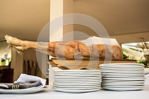 Chef slices serrano ham. Jamon Serrano. Typical Spanish delicate