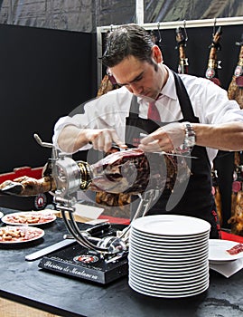 Chef slicing jamon iberico