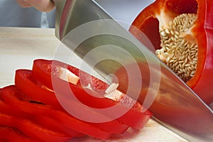 Chef Slicing A Red Pepper With Sharp Knife