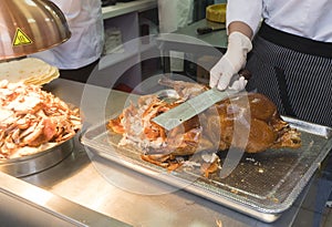 Chef slicing roasted Peking duck