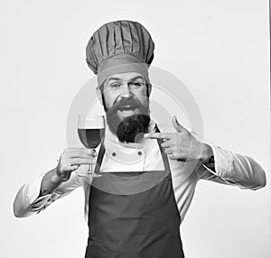 Chef or sommelier with red cabernet or merlot. Professional wine tasting concept. Man with beard