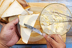 Chef spreading butter cheese on slide bread