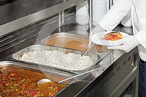 Chef standing behind full lunch service station