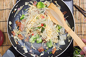 Chef stir fried Spaghetti with ladle