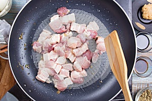 Chef stirfry streaky pork in pan