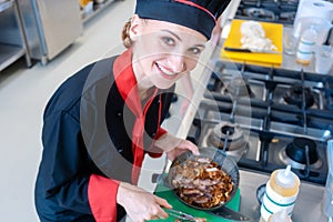 Chef stirring pasta in restaurant kitchen