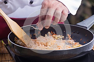 Chef stitr fried rice noodle for cooking Pad Thai