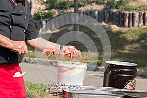 Chef strung pieces of meat