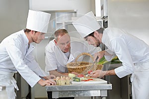 Chef supervising trainees cooking