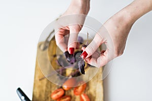 The chef tears off the leaves of basalica. Top view, white background. photo