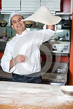 Chef throwing the pizza base dough