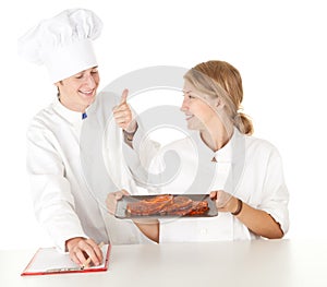 Chef with thumb up examining cook
