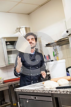 Chef tossing dough while making pastries