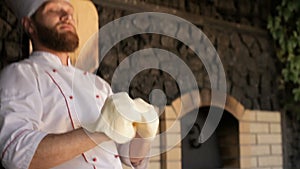 Chef tossing pizza dough in restaurant