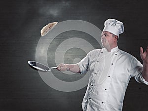 Chef turns fresh pancakes in the pan