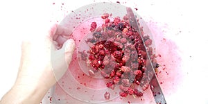 Chef uses a knife to cut Mulberry into small pieces. The process of making mulberry juice healthy menu