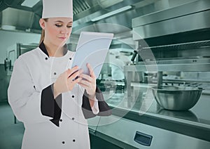 Chef using digital tablet in commercial kitchen