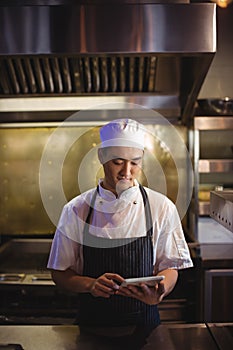 Chef using digital tablet in the commercial kitchen