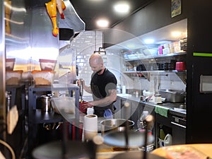 Chef using an electric mixer in the kitchen of a restaurant