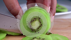 The chef is using a fresh kiwi slicing knife. For cooking