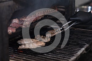 A chef in a very nice pub smokes pork ribs in a large oven.