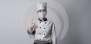 Chef wearing face protective medical mask for protection virus