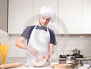 Chef whisked eggs and meal in a bowl