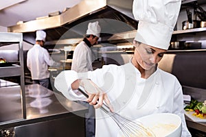 Chef whisking bowl of eggs